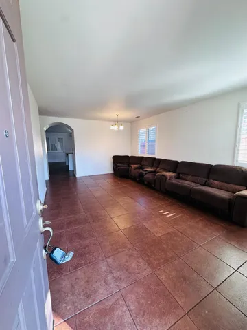 a living room with a couch and a stove top oven