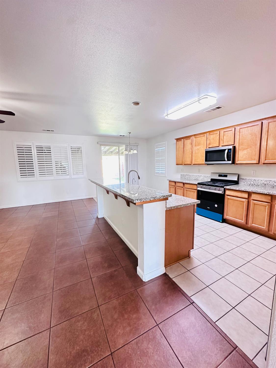6642 East Cetti Avenue Fresno, CA 93727 - Photo 6 of 18 a large kitchen with stainless steel appliances a stove a sink a counter top space and cabinets