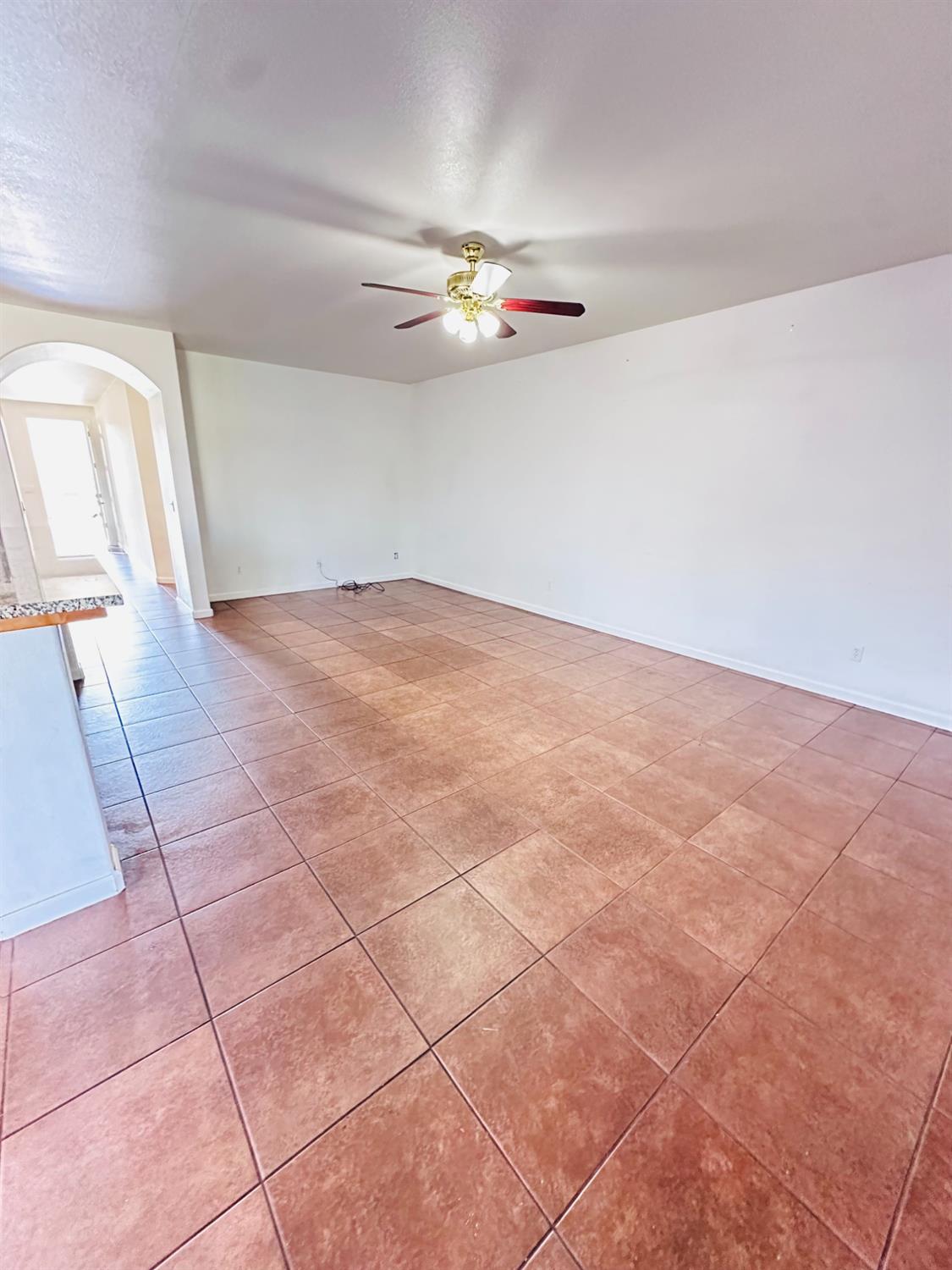 6642 East Cetti Avenue Fresno, CA 93727 - Photo 8 of 18 an empty room with windows and ceiling fan