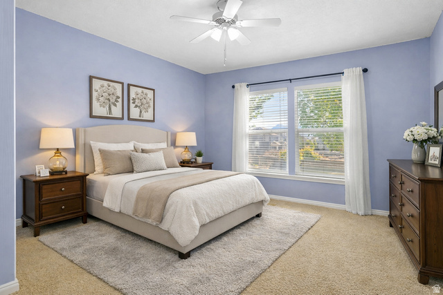 7092 Cherokee Street Eagle Mountain, UT 84005 - Photo 8 of 27 Bedroom featuring a ceiling fan, dual windows with blinds, light blue wall paint, and carpet flooring