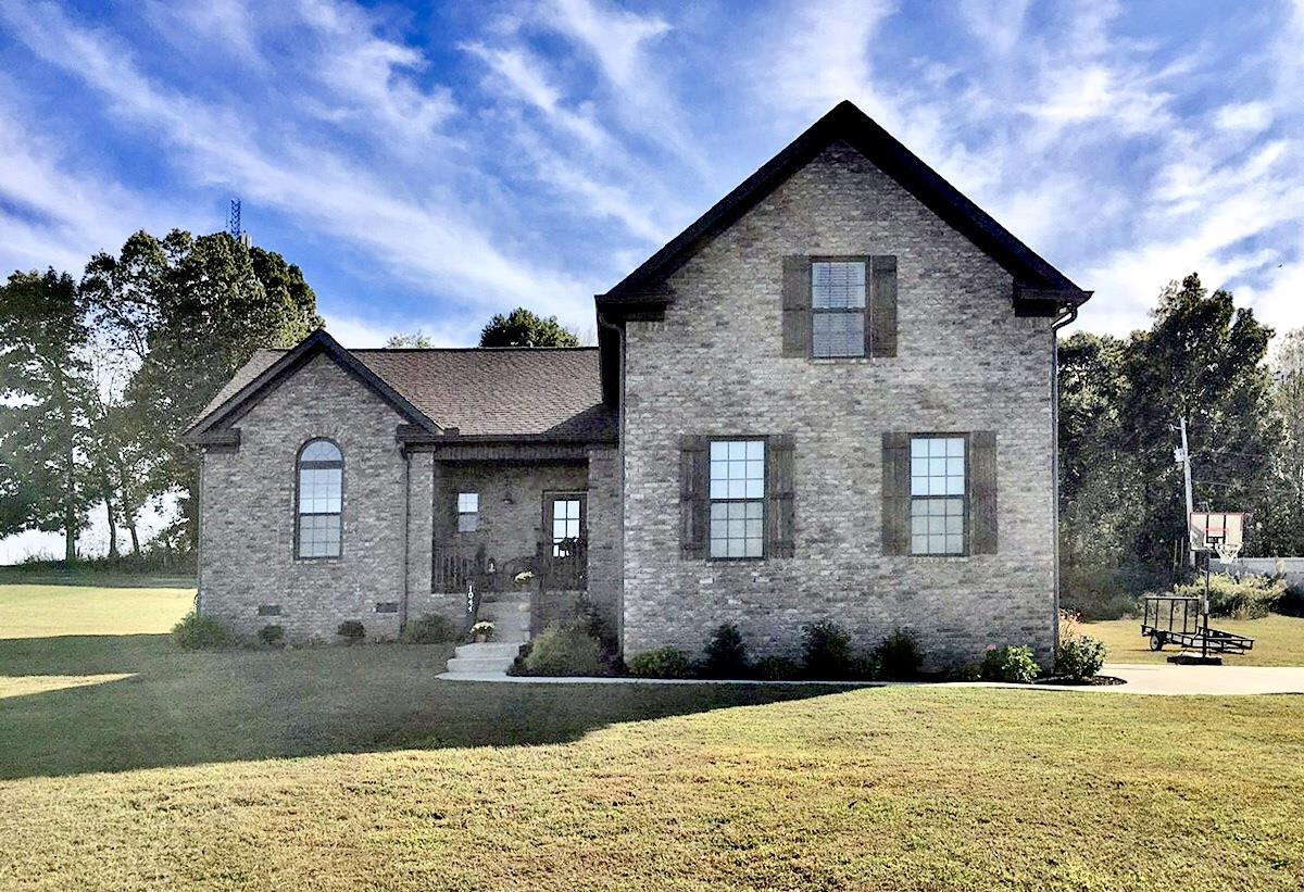 a front view of a house with a yard