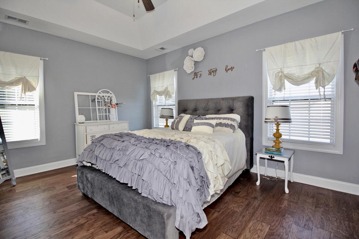 1044 Luton Way White House, TN 37188 - Photo 12 of 26 a large bed sitting in a bedroom next to a window and a wooden floor