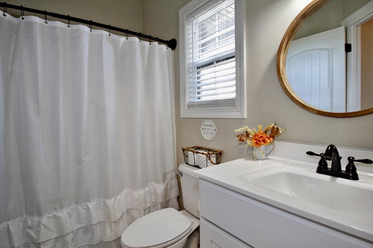 1044 Luton Way White House, TN 37188 - Photo 21 of 26 a bathroom with a sink a toilet and a mirror