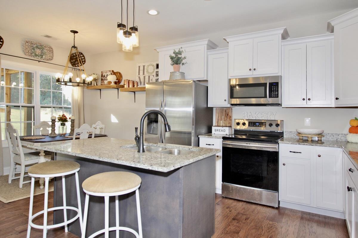 1044 Luton Way White House, TN 37188 - Photo 8 of 26 a kitchen with stainless steel appliances granite countertop a stove a sink dishwasher a microwave oven with granite countertops and cabinets