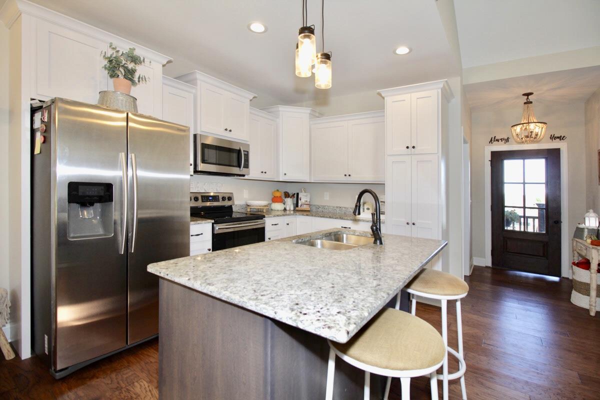 1044 Luton Way White House, TN 37188 - Photo 10 of 26 a kitchen with stainless steel appliances granite countertop a kitchen island a stove a table and chairs