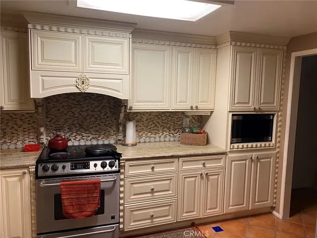 a kitchen with stainless steel appliances granite countertop a stove and a microwave