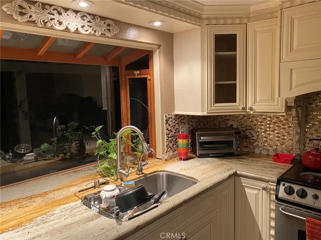 a kitchen with a sink and a stove top oven