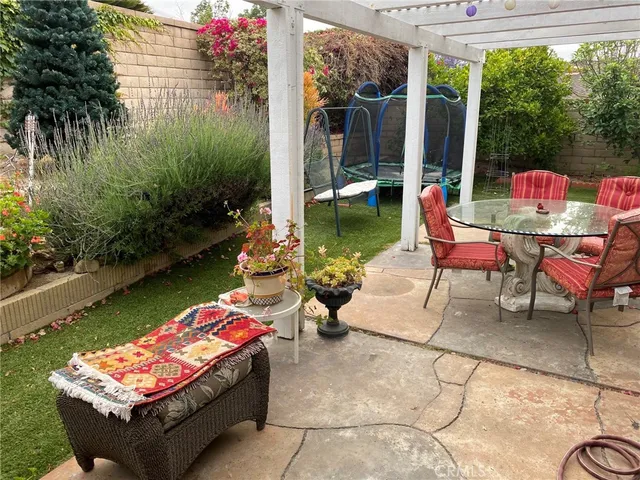 a swimming pool with outdoor seating and yard