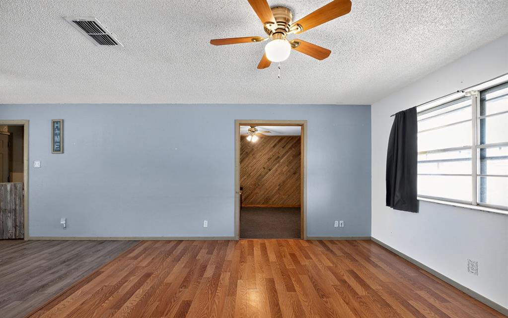 604 Fegan Street Weatherford, TX 76086 - Photo 11 of 36 wooden floor in an empty room with a window