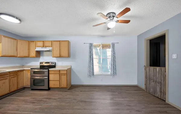 a kitchen with cabinets a sink and appliances