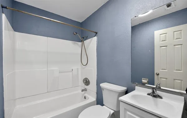 a bathroom with a sink a toilet and mirror