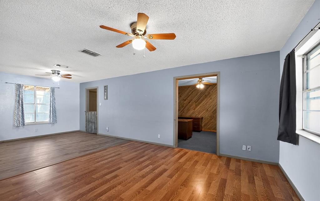 604 Fegan Street Weatherford, TX 76086 - Photo 7 of 36 a view of empty room with wooden floor and fan