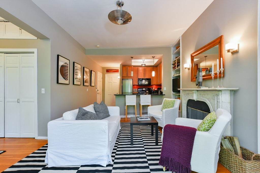 a living room with furniture fireplace and a large mirror