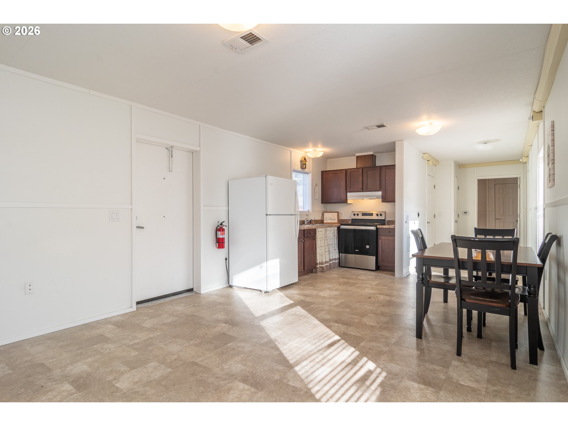 5000 Northeast Stephens Street, Unit 40 Roseburg, OR 97470 - Photo 12 of 27 a view of kitchen with refrigerator stove dining table and chairs