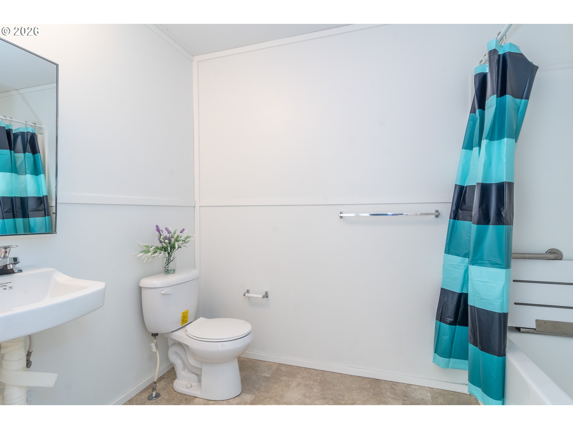 5000 Northeast Stephens Street, Unit 40 Roseburg, OR 97470 - Photo 19 of 27 a bathroom with a toilet a sink and mirror