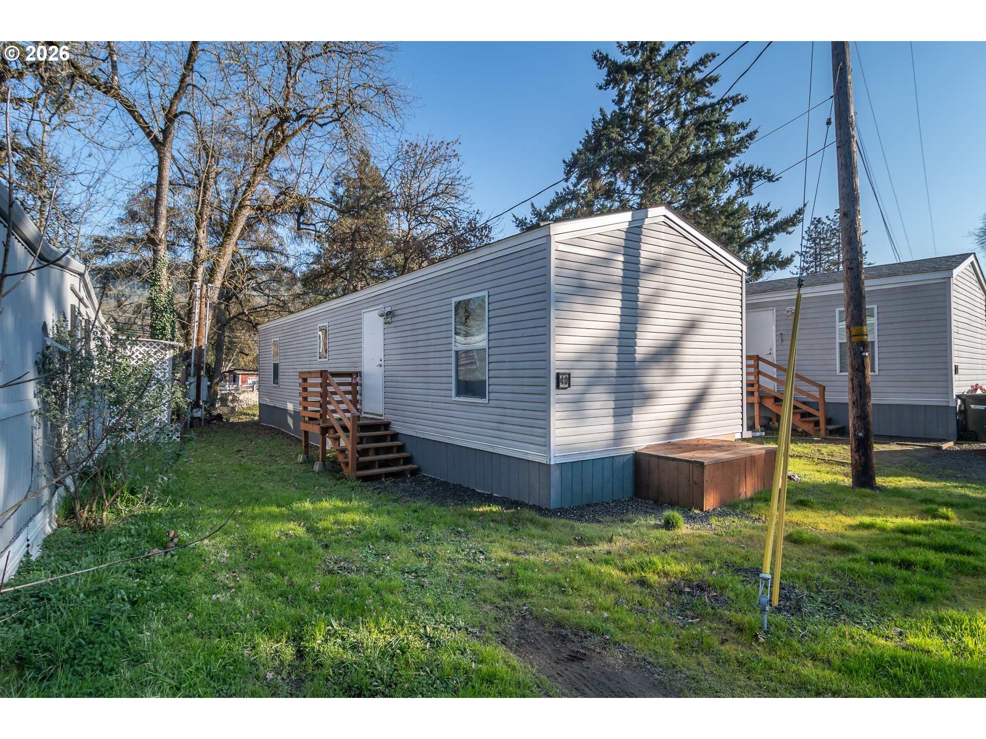 5000 Northeast Stephens Street, Unit 40 Roseburg, OR 97470 - Photo 27 of 27 a view of a backyard with plants and a large tree