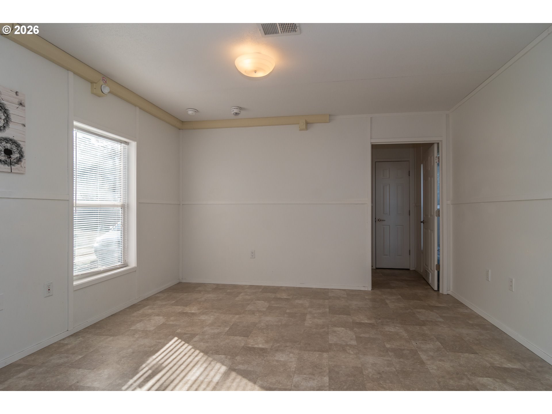 5000 Northeast Stephens Street, Unit 40 Roseburg, OR 97470 - Photo 5 of 27 a view of an empty room with a window