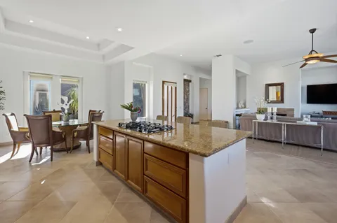 a kitchen with stainless steel appliances granite countertop a sink and a stove