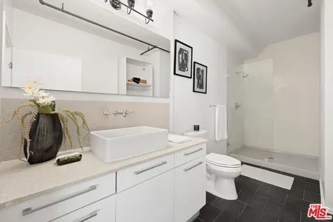 a view of bathroom with a toilet sink and mirror