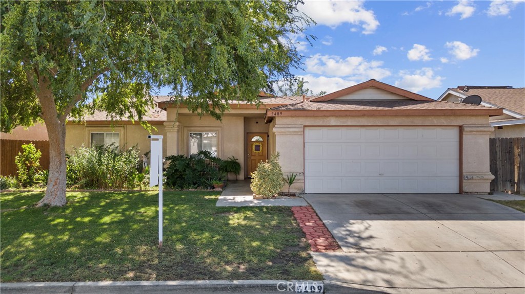5409 Grant Grove Street Bakersfield, CA 93307 - Photo 1 of 1 a front view of a house with garden