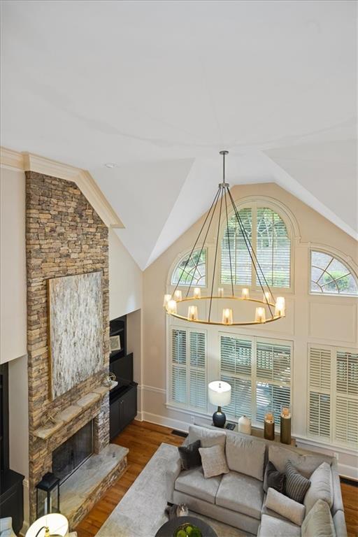 208 Grandmar Chase Canton, GA 30115 - Photo 13 of 67 a living room with furniture a fireplace and a chandelier