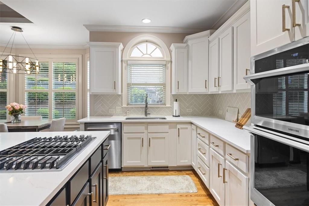 208 Grandmar Chase Canton, GA 30115 - Photo 15 of 67 a kitchen with a stove a sink and a window