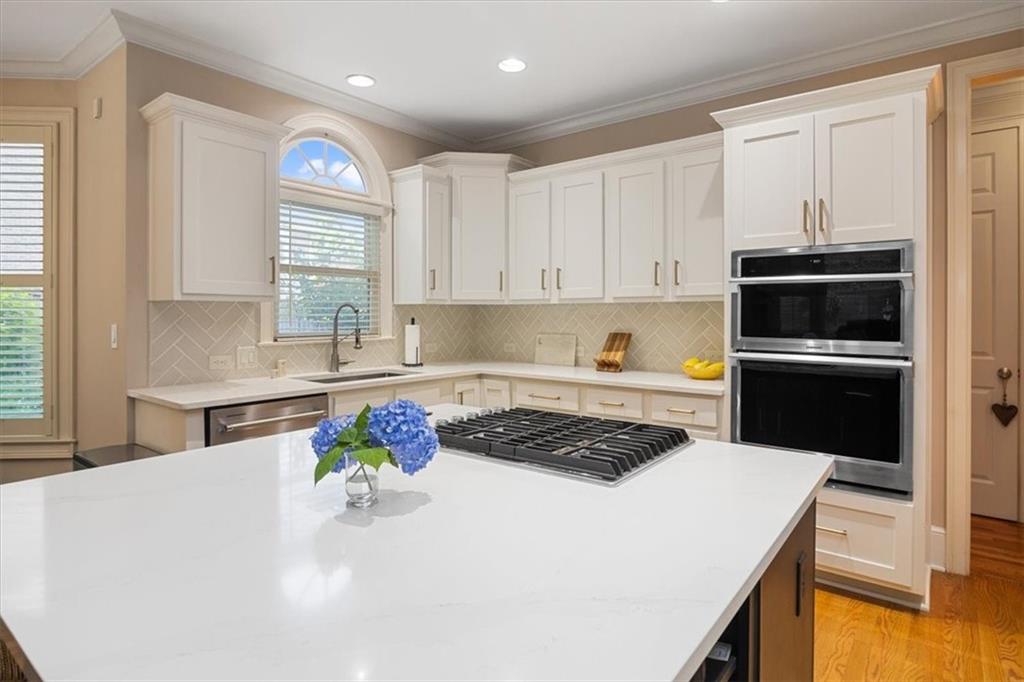 208 Grandmar Chase Canton, GA 30115 - Photo 16 of 67 a kitchen with stainless steel appliances a sink a stove a microwave and a refrigerator