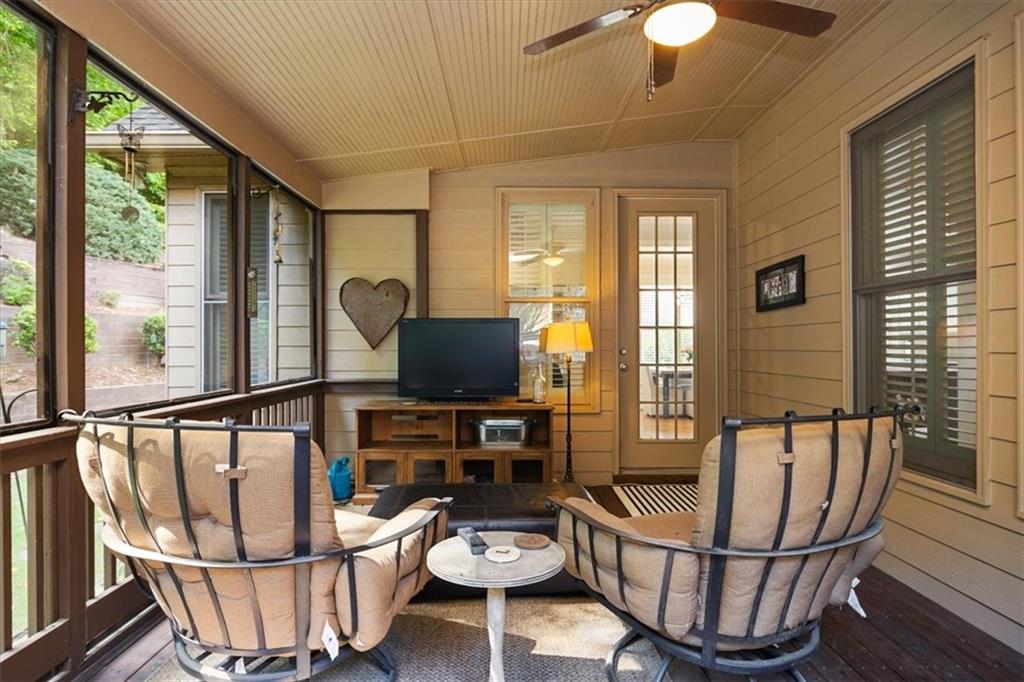 208 Grandmar Chase Canton, GA 30115 - Photo 21 of 67 a living room with furniture a flat screen tv and floor to ceiling windows