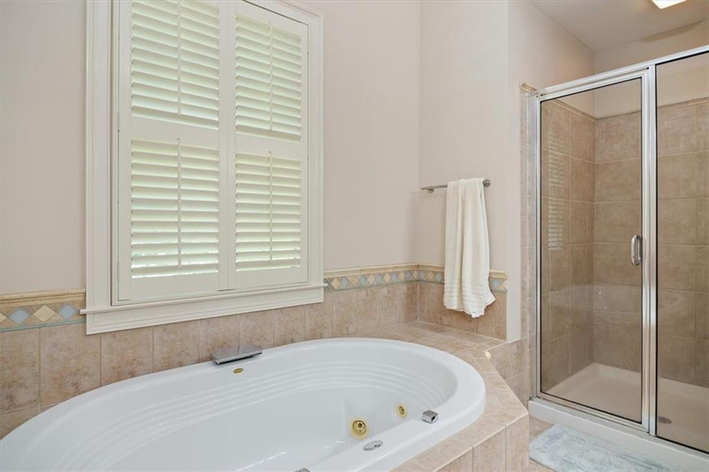 208 Grandmar Chase Canton, GA 30115 - Photo 27 of 67 a white bath tub sitting next to a shower