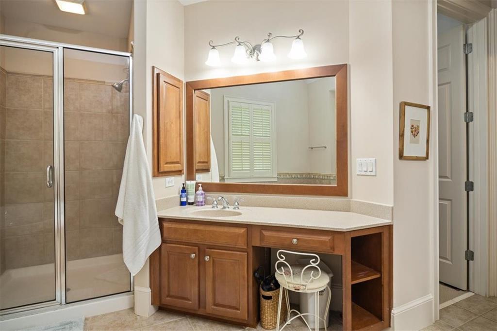 208 Grandmar Chase Canton, GA 30115 - Photo 28 of 67 a bathroom with a sink a mirror and a shower