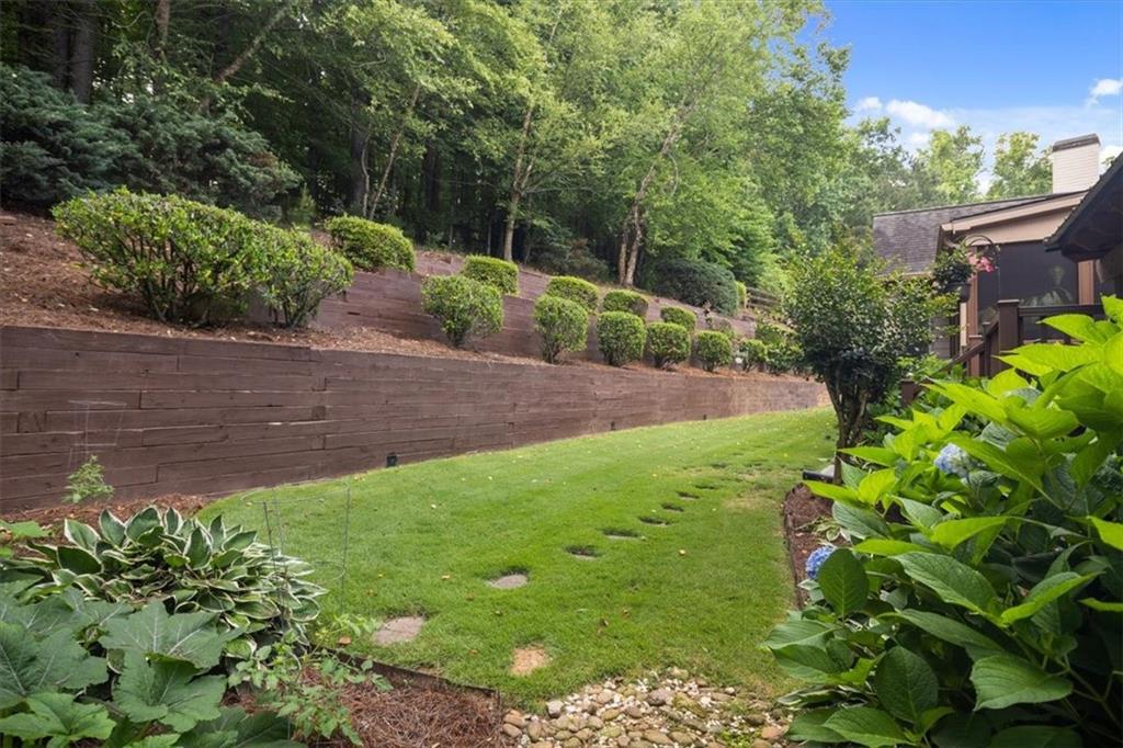 208 Grandmar Chase Canton, GA 30115 - Photo 49 of 67 a view of a yard with plants and large trees
