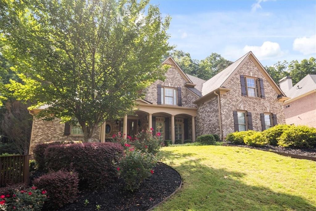 208 Grandmar Chase Canton, GA 30115 - Photo 65 of 67 a front view of a house with a garden