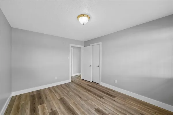a view of room with wooden floor and ceiling fan