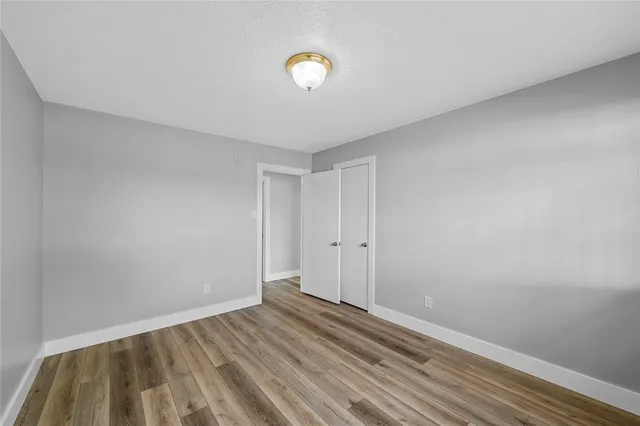 a view of room with wooden floor and ceiling fan