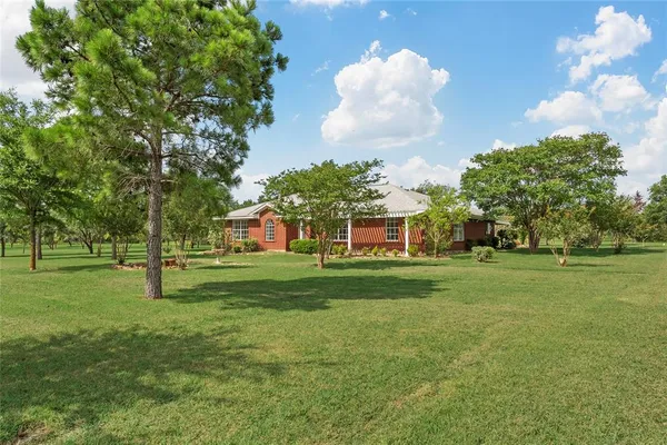 a view of a house with a big yard