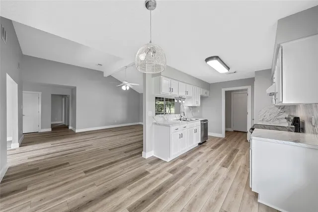 a large kitchen with kitchen island a sink stainless steel appliances and cabinets