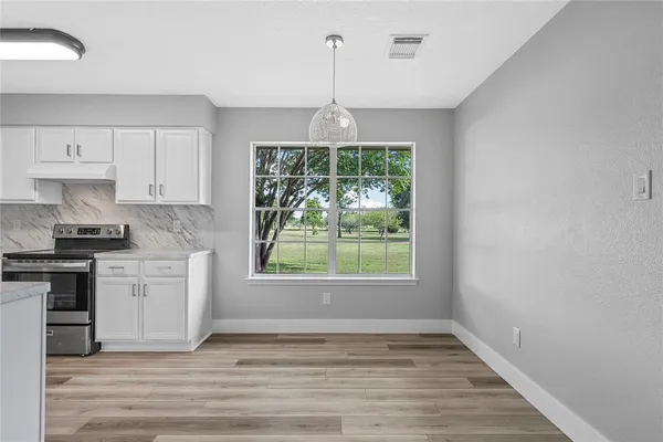 a view of a kitchen with a sink dishwasher and wooden floor