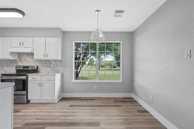 a view of a kitchen with a sink dishwasher and wooden floor