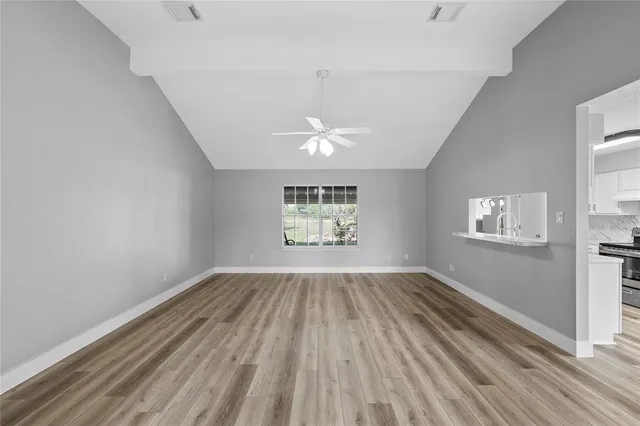 wooden floor in an empty room with a window