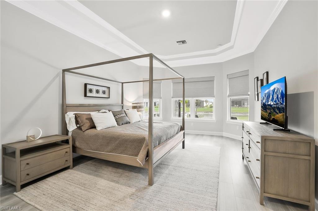 15804 Derna Street Naples, FL 34114 - Photo 12 of 28 Bedroom featuring a tray ceiling