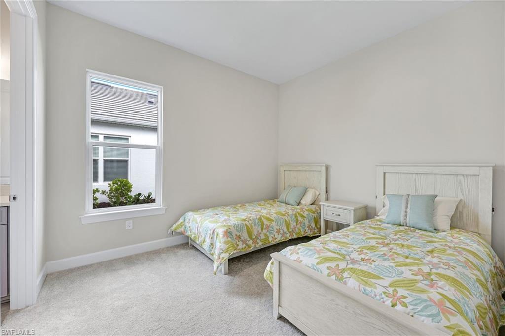 15804 Derna Street Naples, FL 34114 - Photo 18 of 28 Bedroom with light colored carpet and baseboards