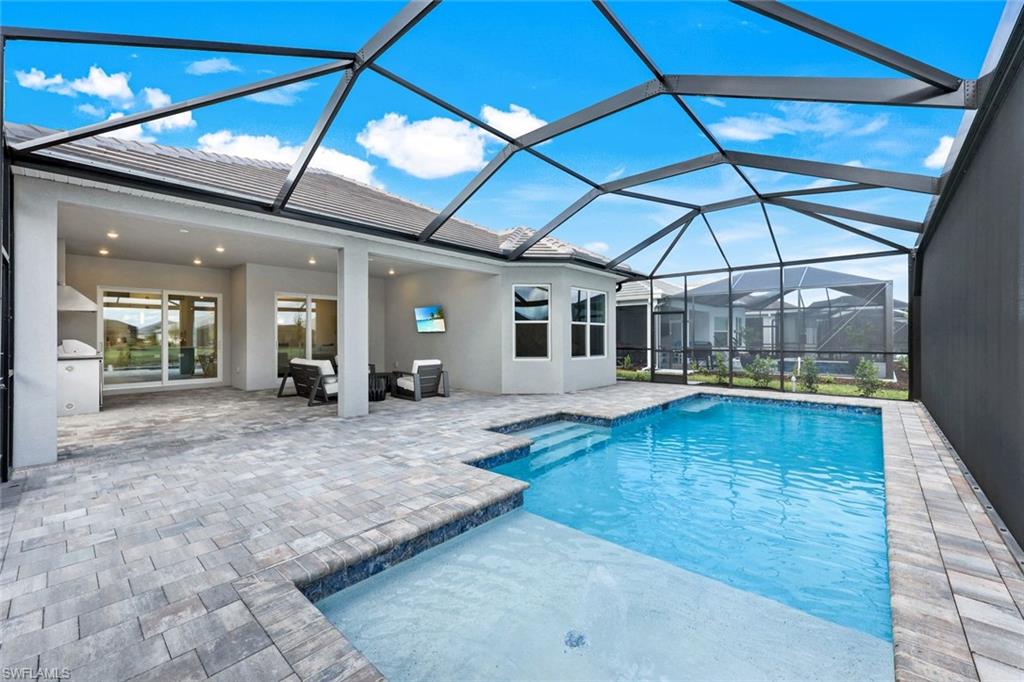 15804 Derna Street Naples, FL 34114 - Photo 20 of 22 Swimming pool featuring a sunroom, glass enclosure, and a patio area