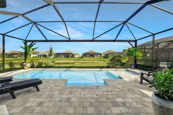 a view of swimming pool with outdoor seating and a yard