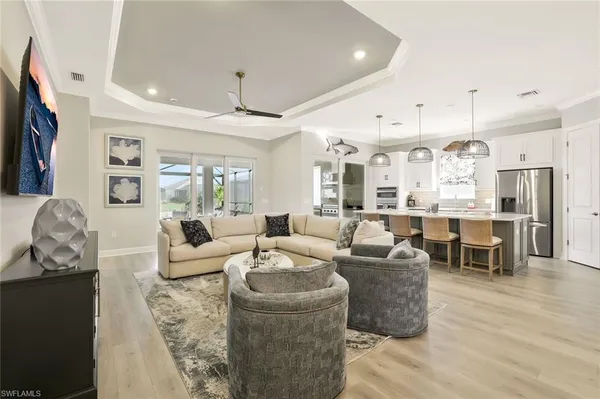 a living room with fireplace furniture and a flat screen tv