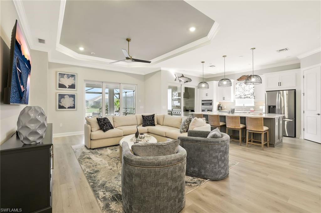 15804 Derna Street Naples, FL 34114 - Photo 4 of 28 Living room featuring light wood-style floors, crown molding, a ceiling fan, and recessed lighting
