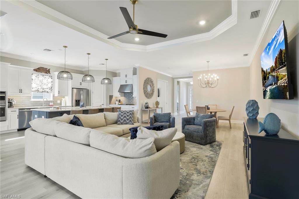 15804 Derna Street Naples, FL 34114 - Photo 6 of 28 Living room featuring ceiling fan, crown molding, a chandelier, light wood finished floors, and recessed lighting