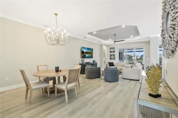a view of a dining room with furniture wooden floor and chandelier