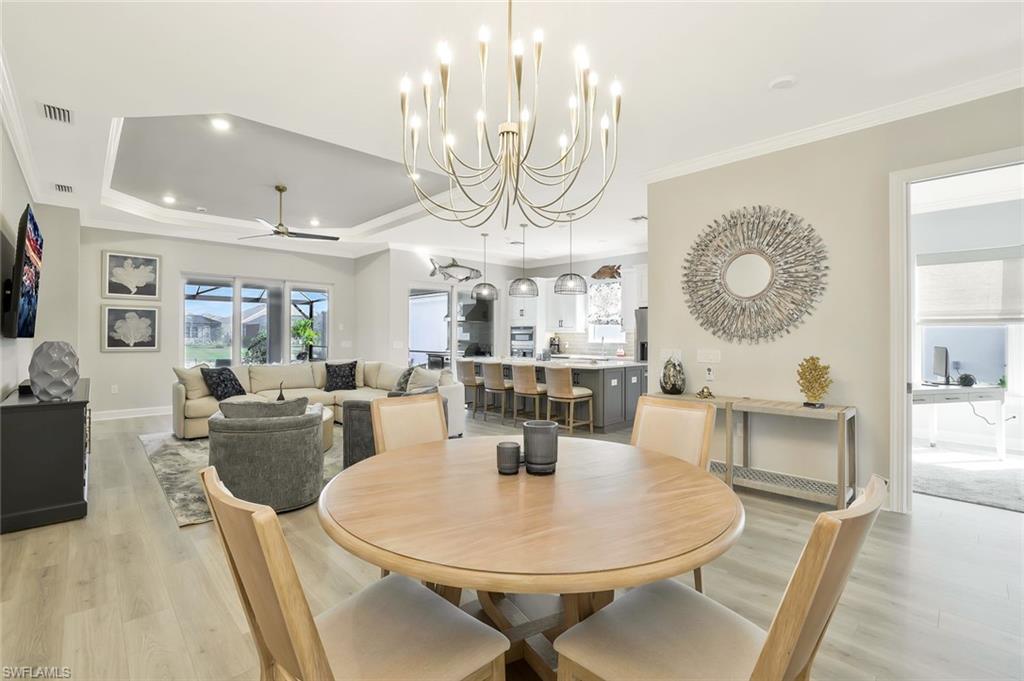 15804 Derna Street Naples, FL 34114 - Photo 8 of 28 Dining space featuring a chandelier, crown molding, light wood-type flooring, a ceiling fan, and recessed lighting