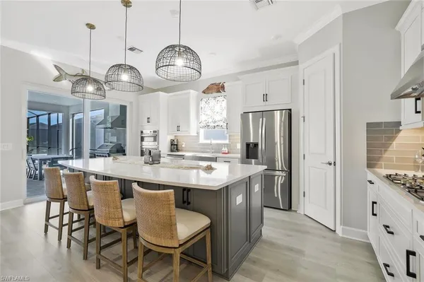 a large kitchen with a table and chairs