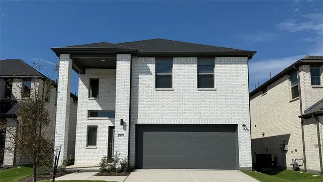 a front view of a house with a garage